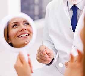 Woman smiling at reflection in mirror