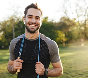 Man smiling while working out in park