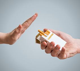 A hand turning down an offer of cigarettes