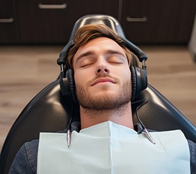 Relaxed dental patient wearing headphones