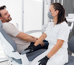 Dentist and patient having friendly conversation